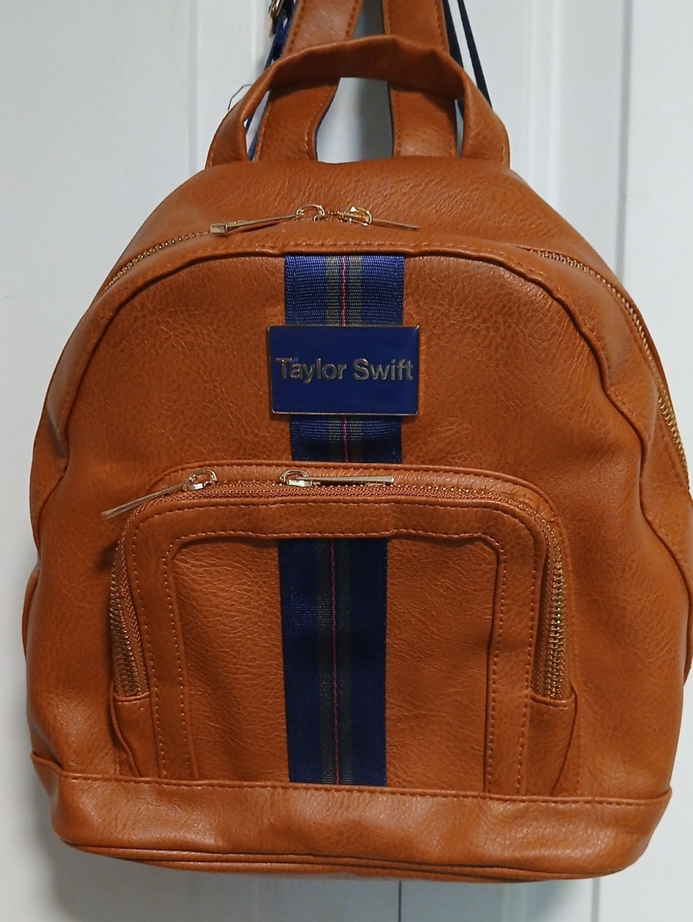 Taylor Swift Tan Backpack with Navy Center Stripe and Gold Hardware